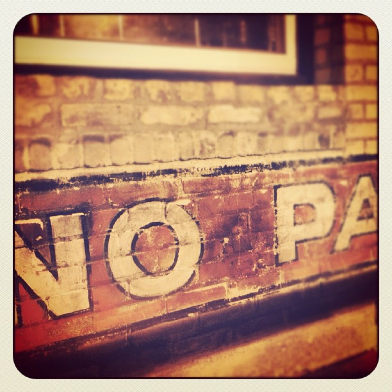Faded sign painting on old brick