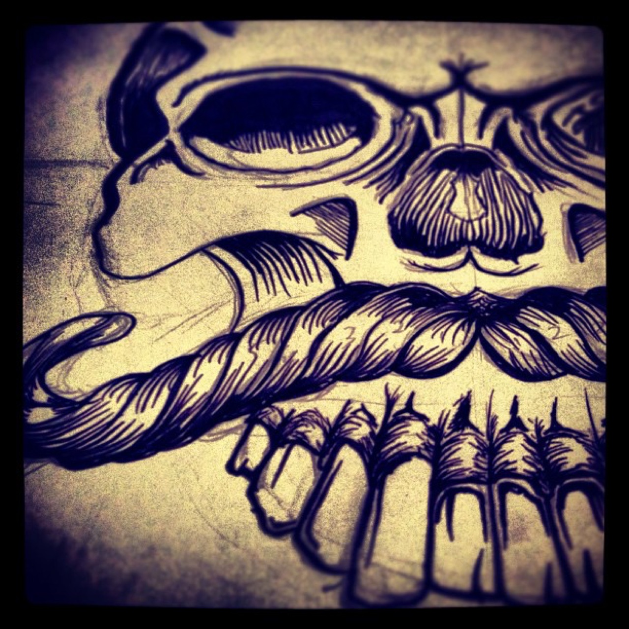 Inking a mustachioed skull