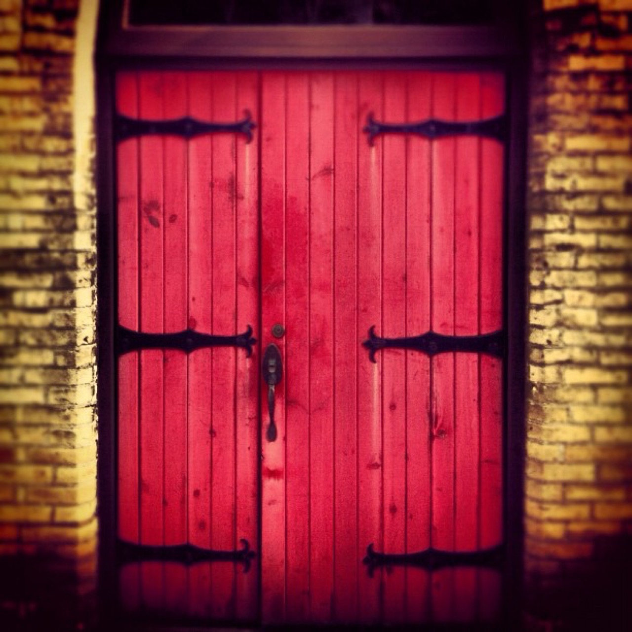 Red doors with iron strap hinges
