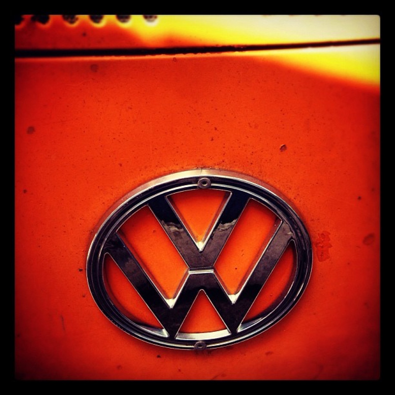 VW badge on orange paint
