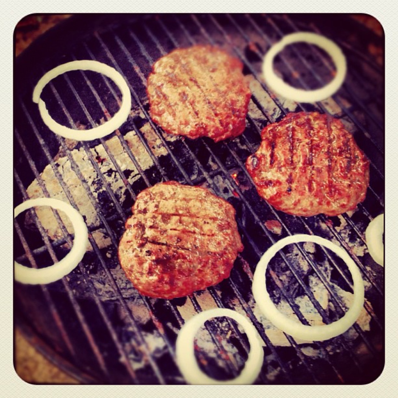 Burgers and onion rings on the grill
