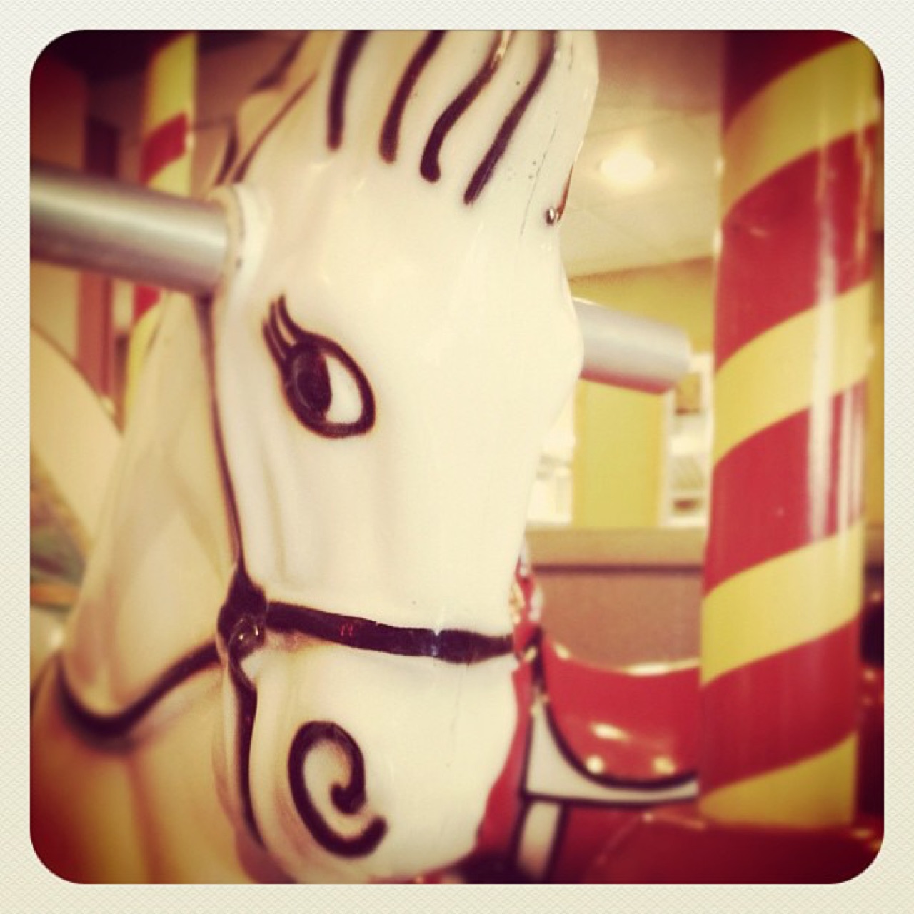 Carousel horse with candy-striped poles