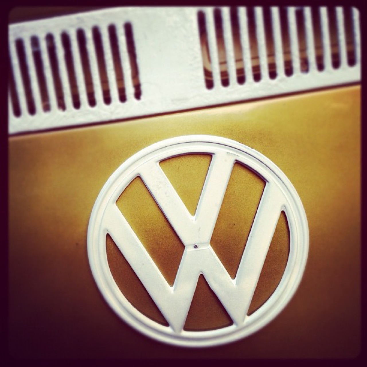 VW emblem on a gold bus