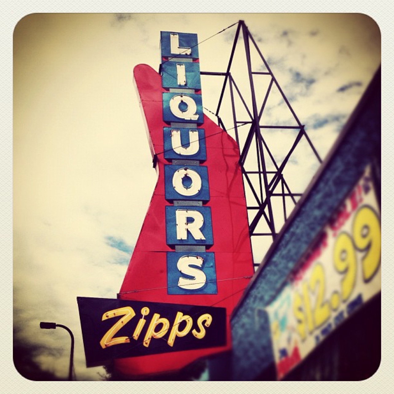 Zipps Liquors sign against the clouds