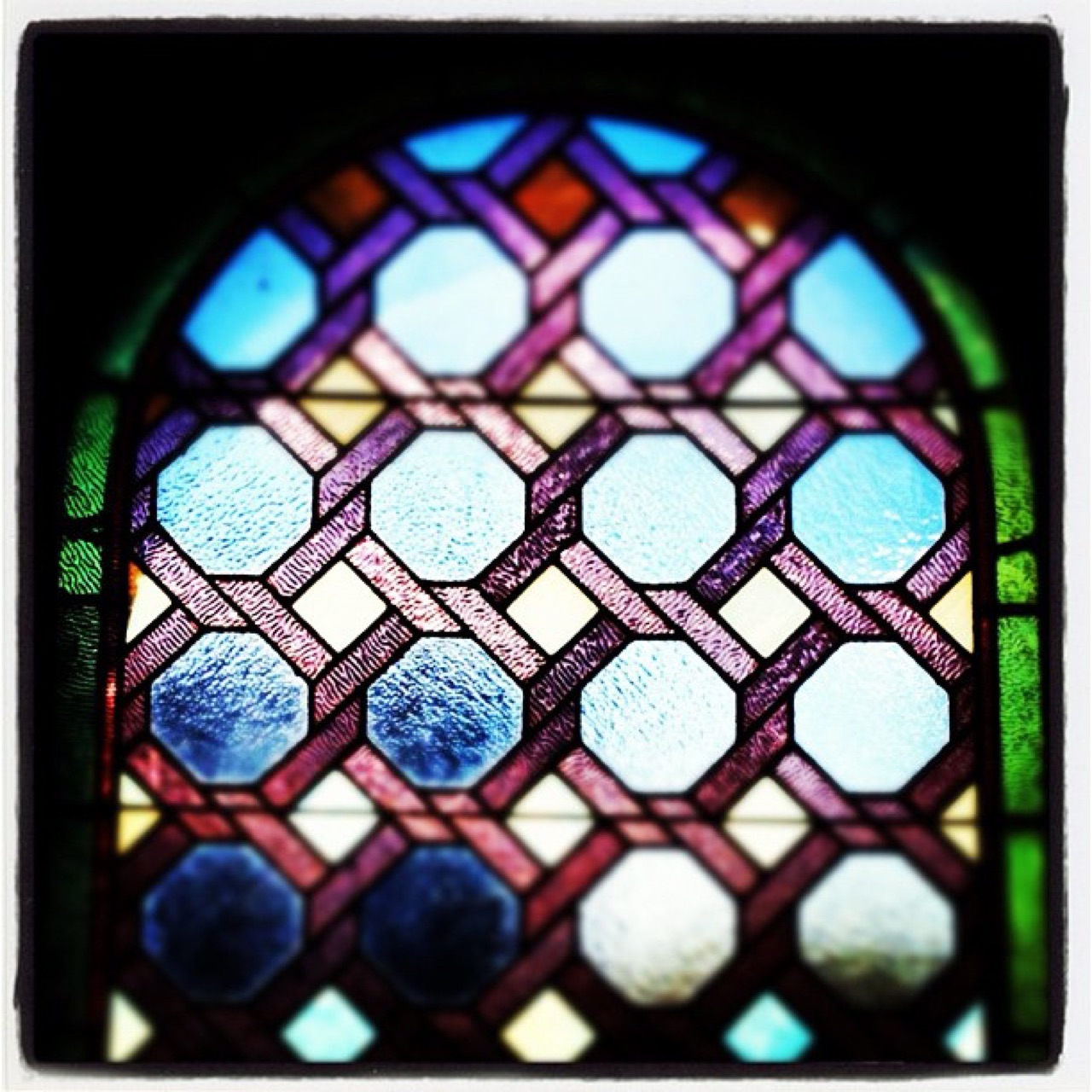 Arched stained glass in blue and violet