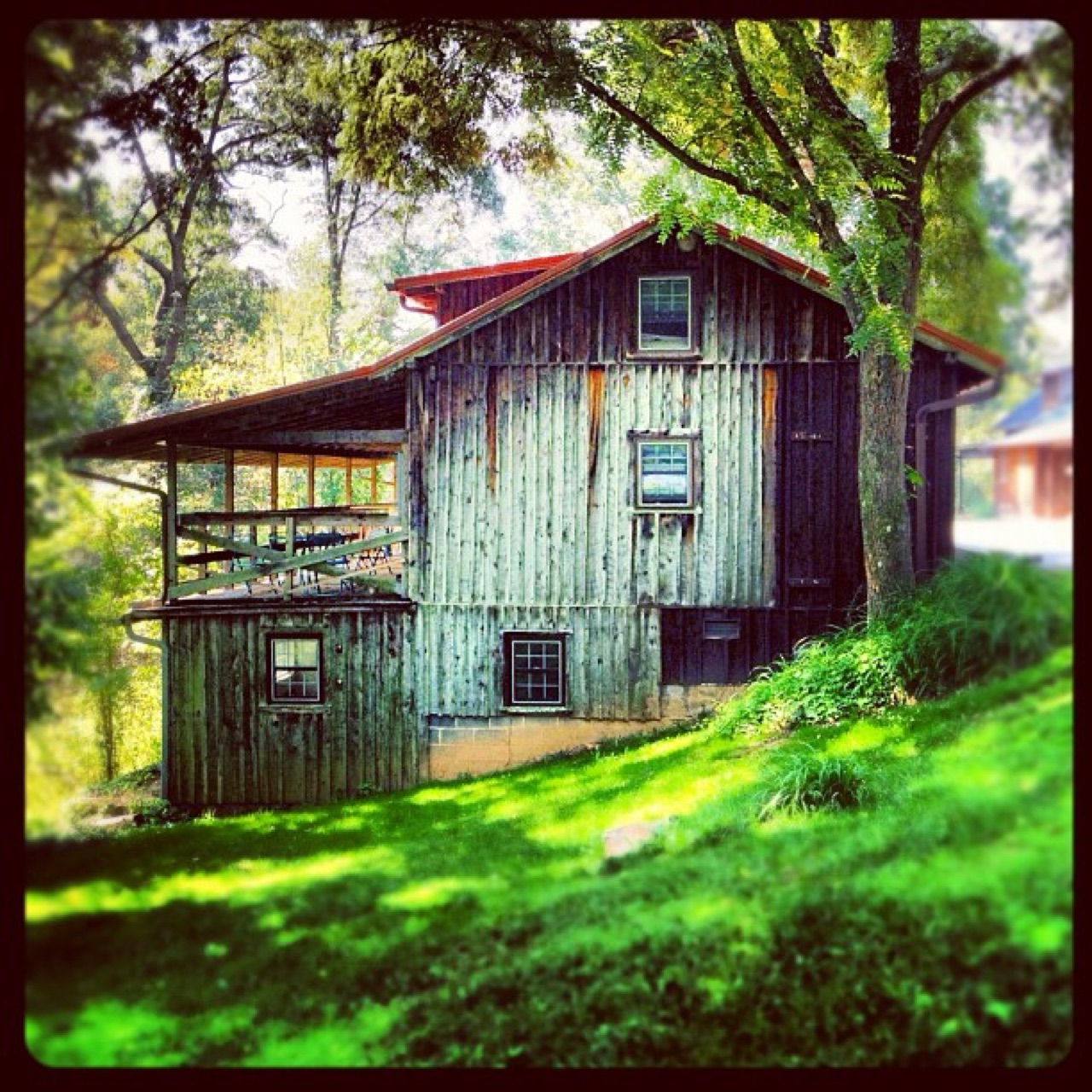Weathered barn on a shaded hillside