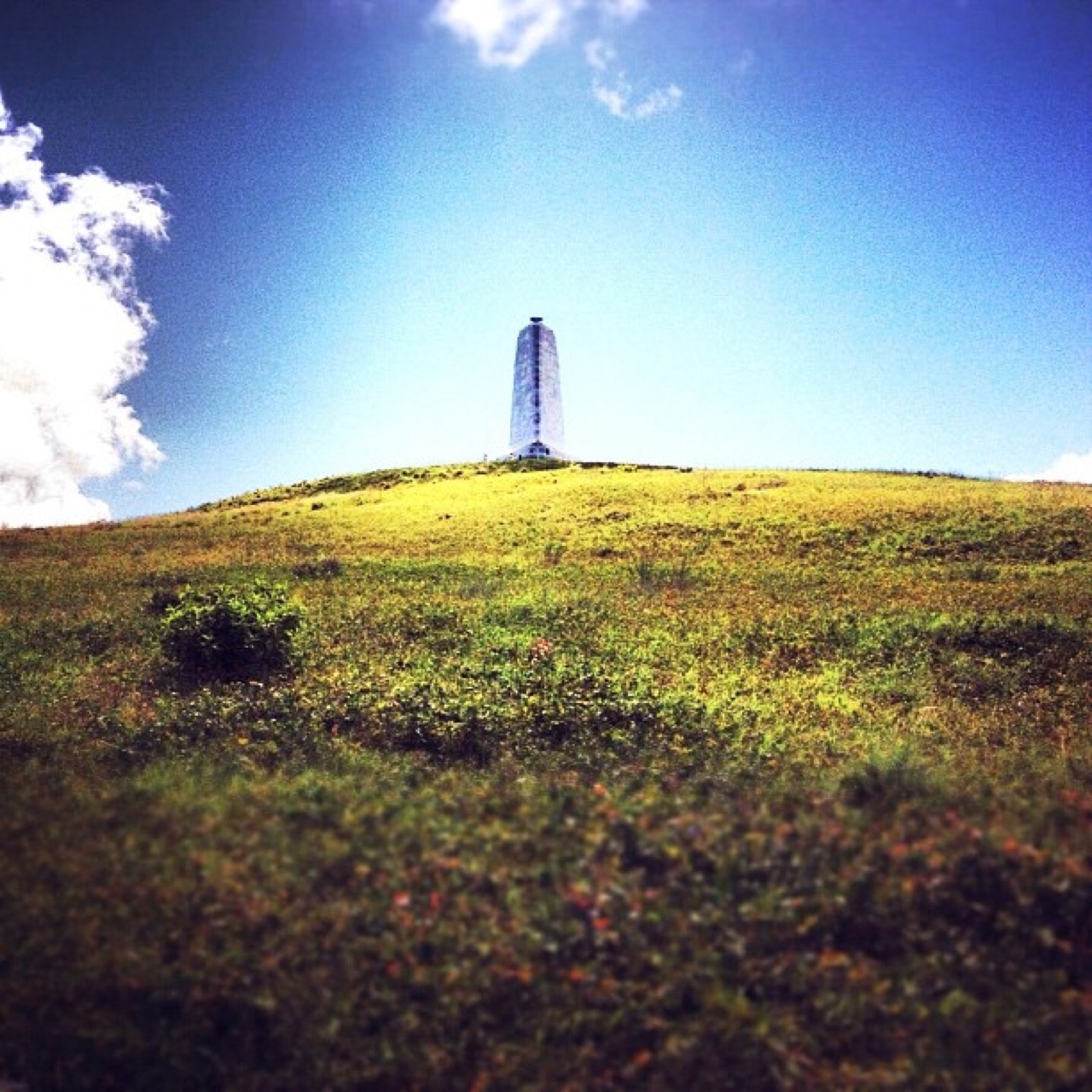Stone monument atop a grassy hill