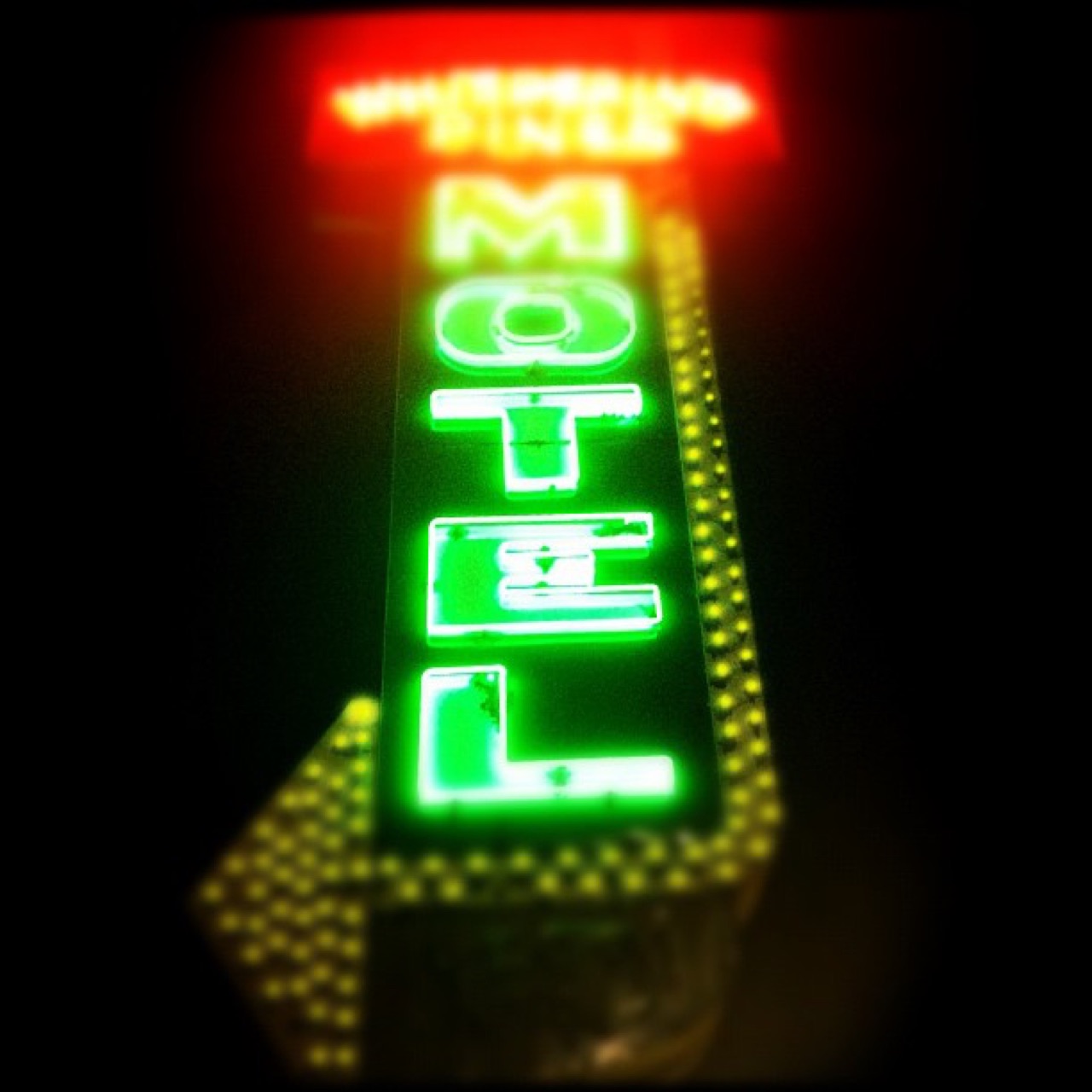 Vertical neon motel sign at night