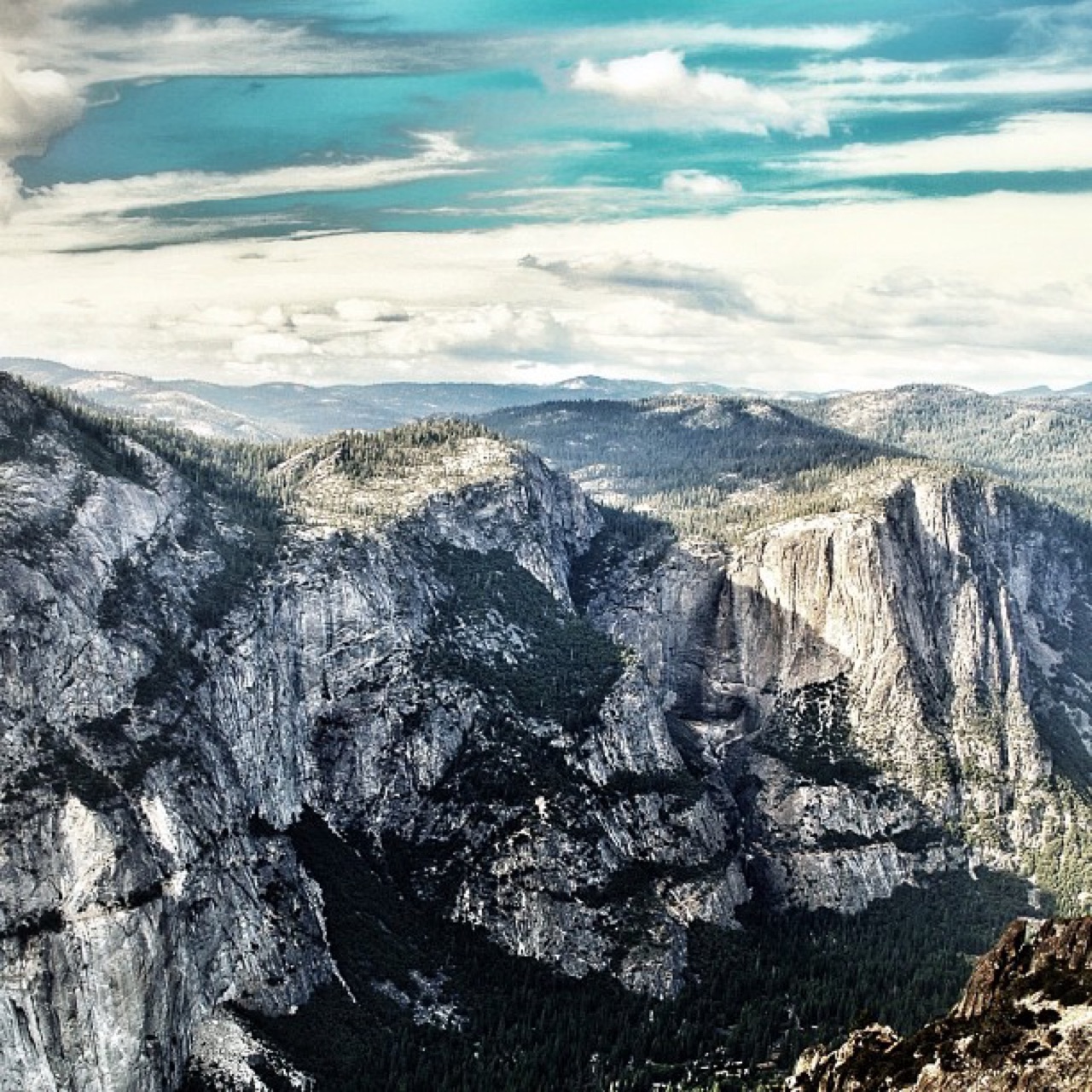 Granite cliffs above a forested valley