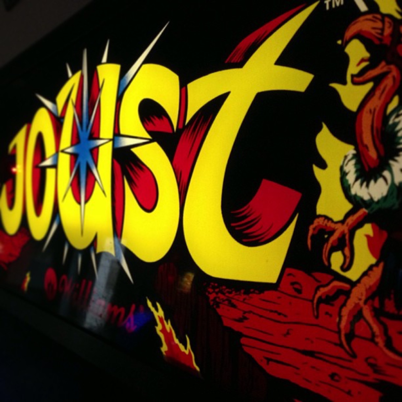 Joust arcade marquee in the dark