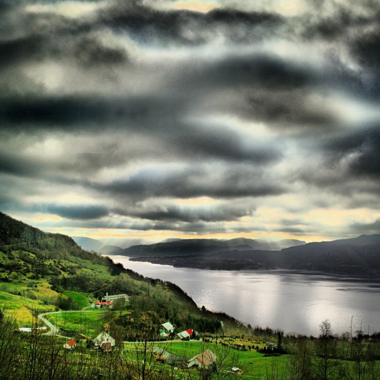 Sunbeams breaking over a fjord valley