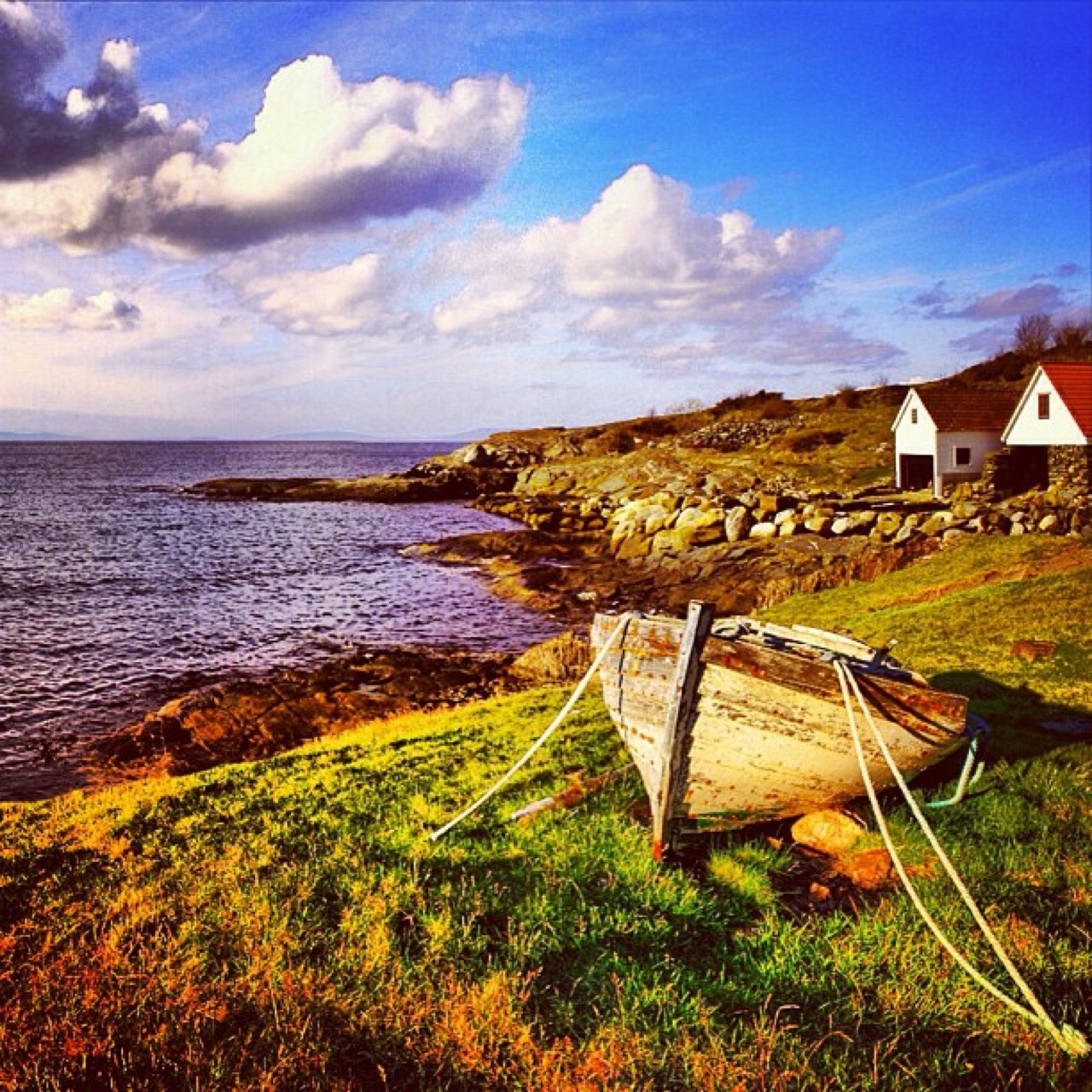 Weathered rowboat hauled out on a rocky cove