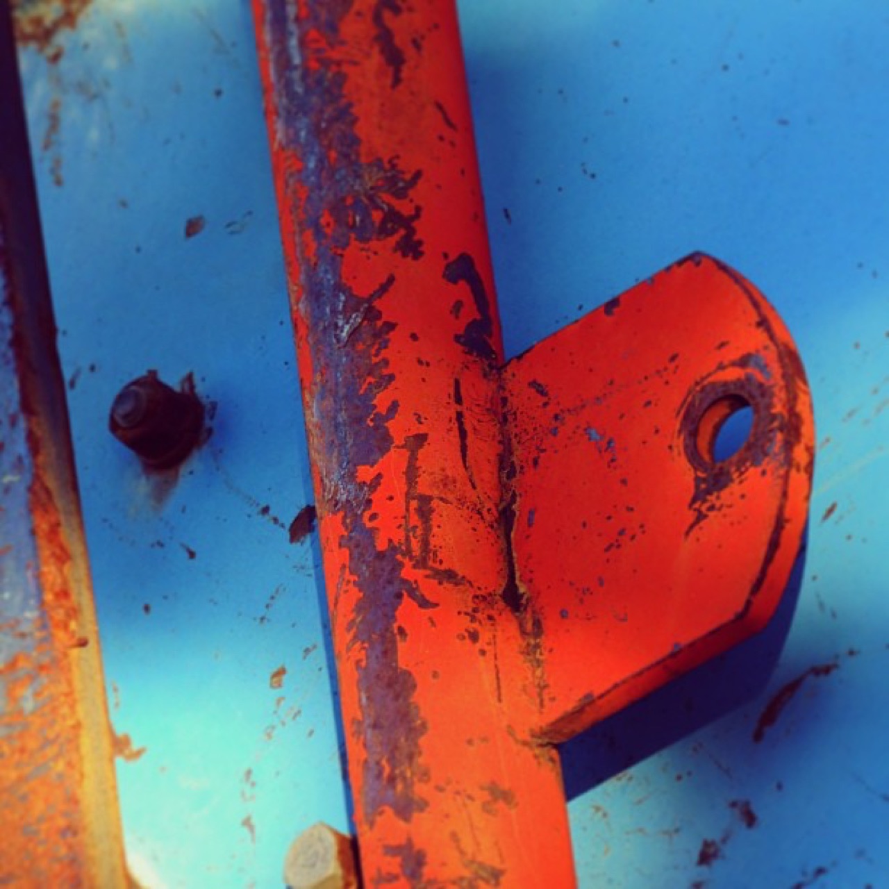Rusted orange latch on blue steel