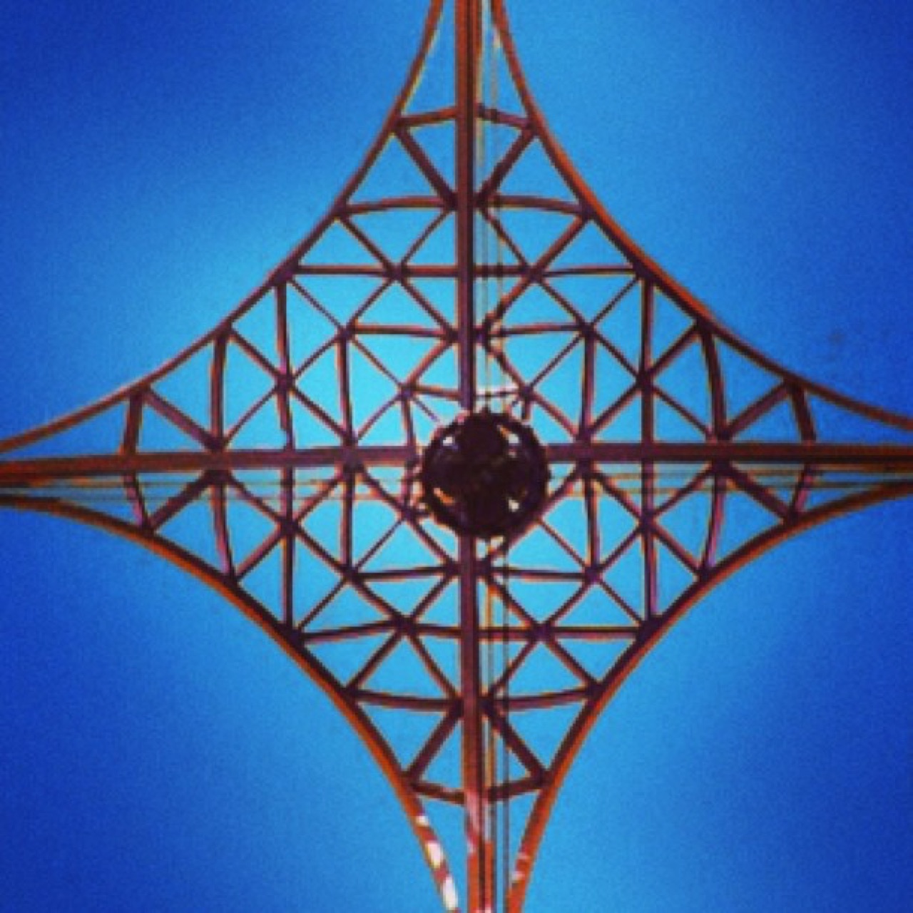 Looking straight up a steel lattice tower