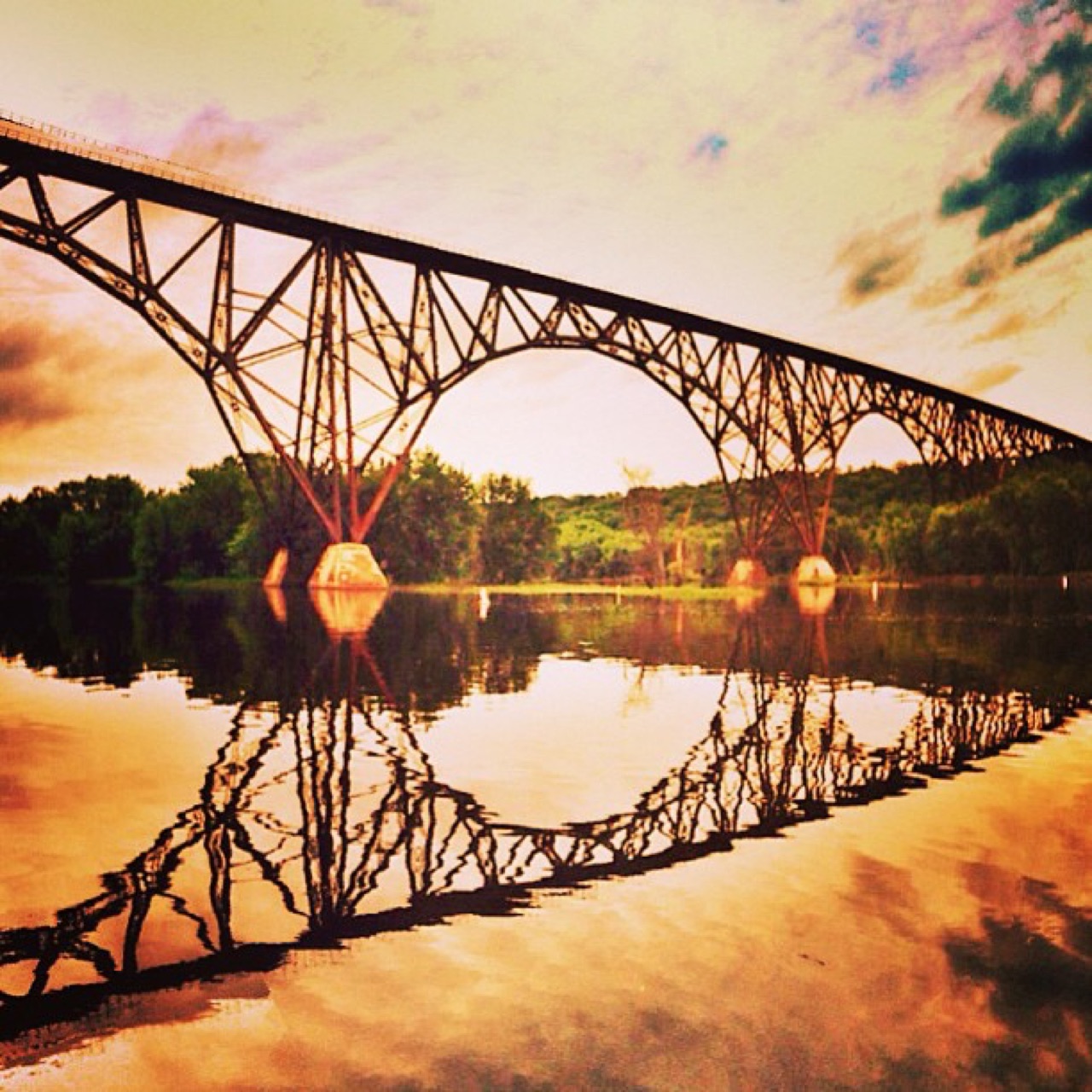 Steel arch bridge mirrored in the river