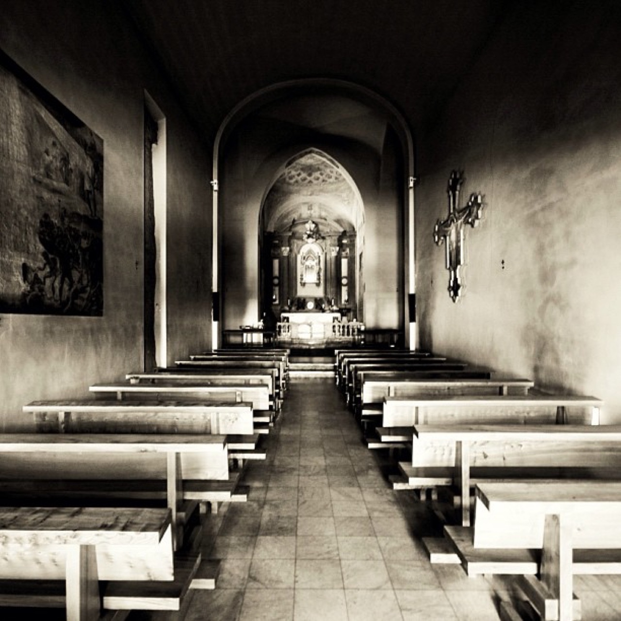 Empty chapel benches facing the altar