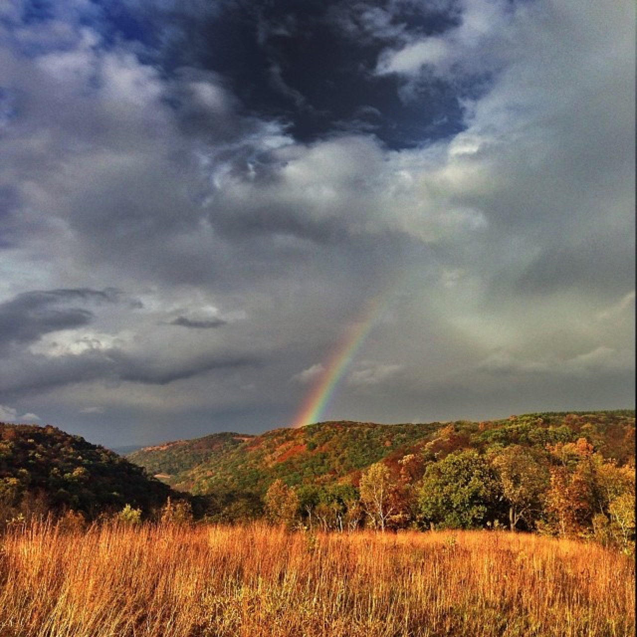Rainbow over autumn hills