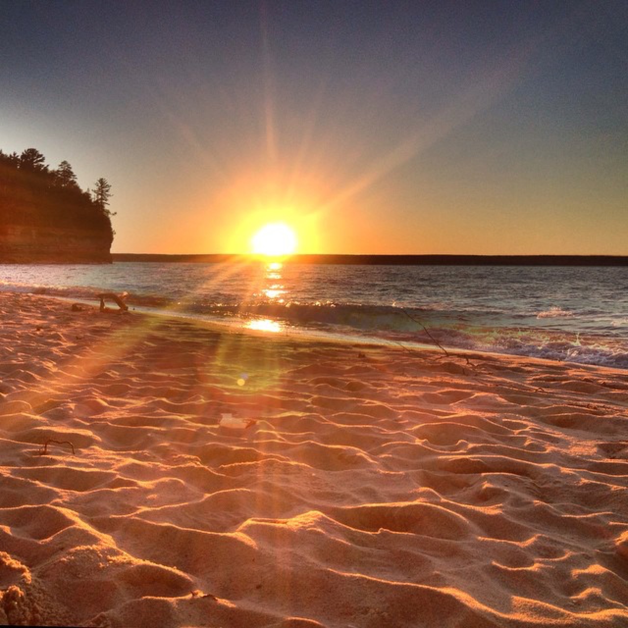 Sunset raking a rippled sand beach