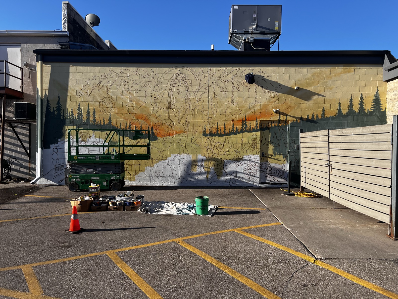 Morning: the drawing now lives on the wall in line, ready to take paint.