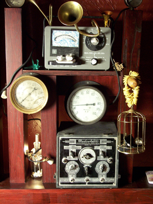Cabinet detail: pre-war radios and gauges, the scientifica of the collection.