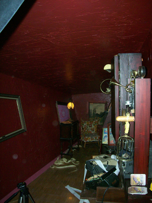 The room itself, a sloped attic furred out and plastered in rough oxblood.